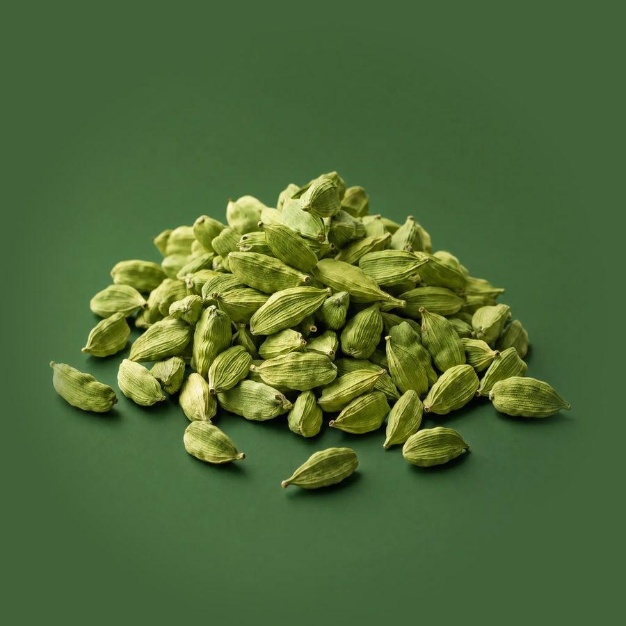 A pile of whole green cardamom pods